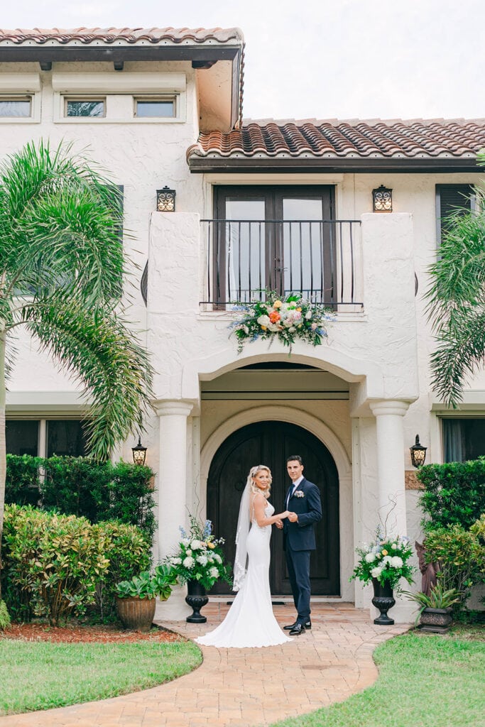 Stunning floral décor by Buds Etc. adorning the villa porch at Bonita Ranch, a Mediterranean-style wedding venue in Melbourne, Florida.