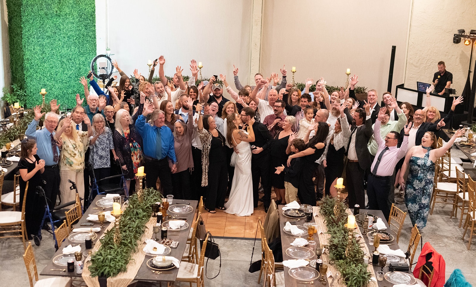 Large wedding reception with guests celebrating at Bonita Ranch venue in Melbourne Florida with plant centerpieces from nursery