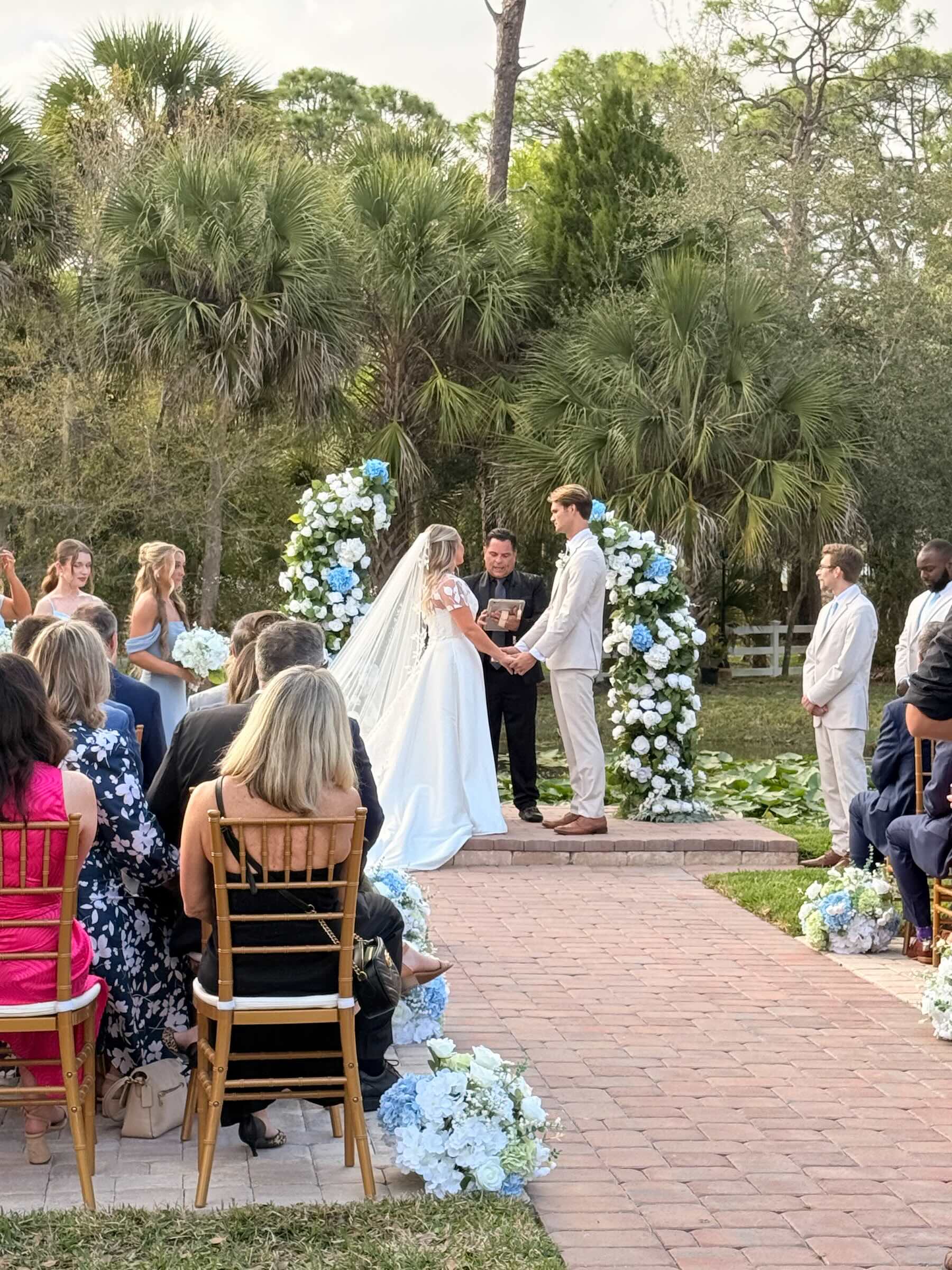 Outdoor garden wedding ceremony at Bonita Ranch venue in Melbourne Florida with bride and groom exchanging vows
