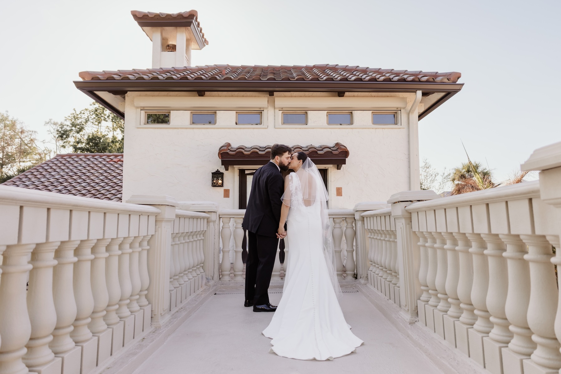 Couple taking wedding portraits on balcony at Bonita Ranch elopement venue in Melbourne Florida