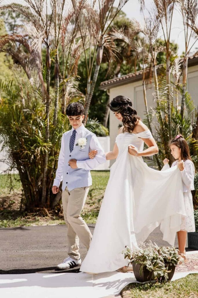 Bride walking to ceremony with children at Bonita Ranch wedding venue in Melbourne Florida