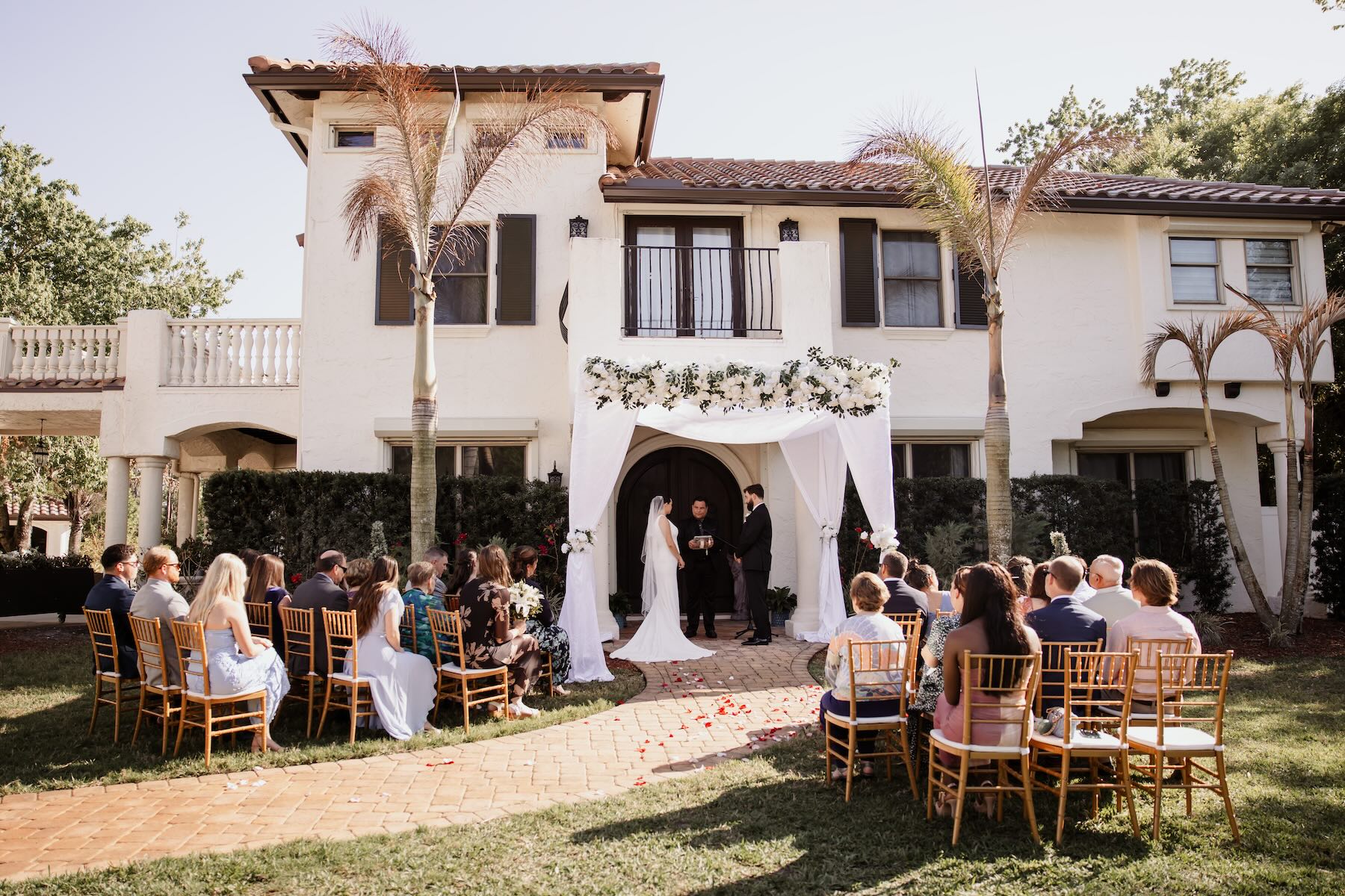 Small elopement wedding ceremony with guests at Bonita Ranch Mediterranean villa venue in Melbourne Florida