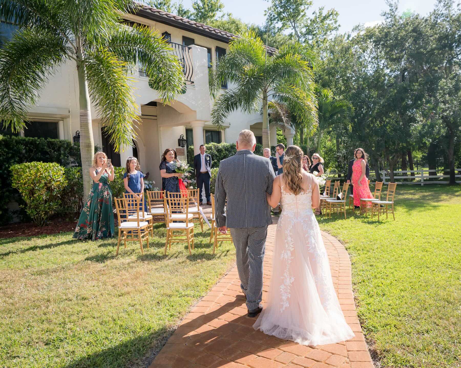 Small intimate wedding ceremony with couple walking down aisle at Bonita Ranch garden venue in Melbourne Florida